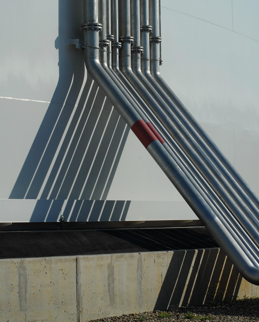 Industrial conduit and piping fanning out from an electrical service structure